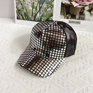 Macro detail of silver sequins on a baseball cap with breathable black mesh back