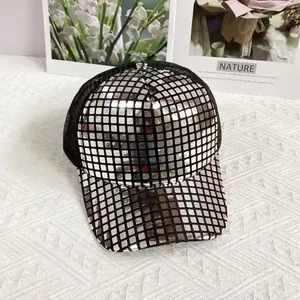 Detail of silver disco-ball style square sequins on a black mesh baseball cap surface
