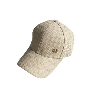 Beige houndstooth baseball cap with a gold metal logo and breathable jacquard fabric