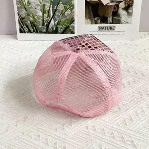 Detail of pink mesh baseball cap featuring shiny disco ball style square sequins
