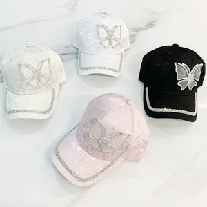 Detail of floral jacquard baseball caps with rhinestone butterfly and trim in three colors