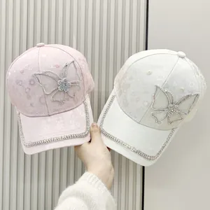Detail of floral baseball cap featuring shimmering butterfly rhinestones and chain trim