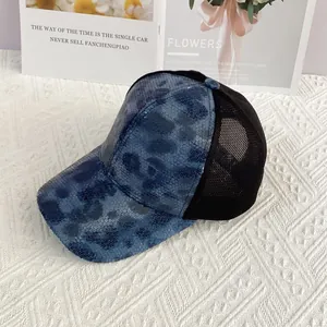 Detail of blue leopard sequins and breathable black mesh on the stylish baseball cap
