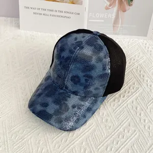 Detailed view of shiny blue and black sequins with breathable mesh on baseball cap