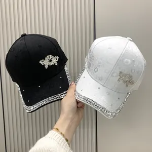 Detail of floral jacquard baseball caps with butterfly rhinestone and sparkling brim