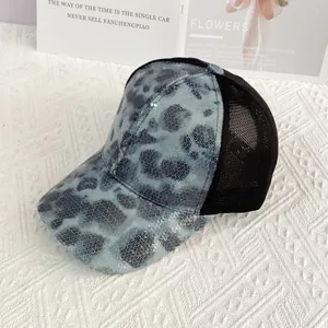 Detailed macro view of light blue leopard sequins and breathable black mesh on a baseball cap