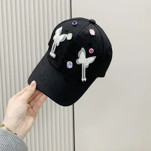 Black baseball cap with translucent butterfly tassels and colorful rhinestones for women