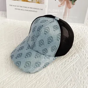 Detail of blue sequin wave patterns on denim baseball cap with breathable mesh back