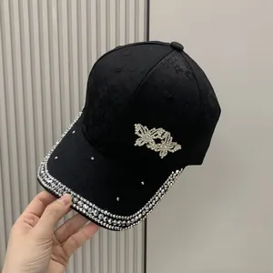 Black satin jacquard baseball cap with sparkling rhinestone butterfly and rim detailing