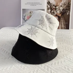 Set of black and white cotton bucket hats with rhinestone spider web patterns