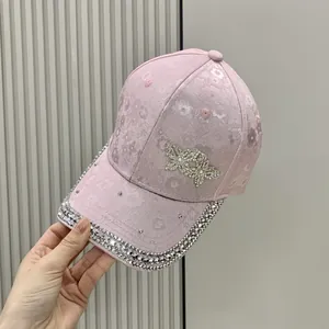 Pink satin baseball cap with floral jacquard, rhinestones and butterfly detail
