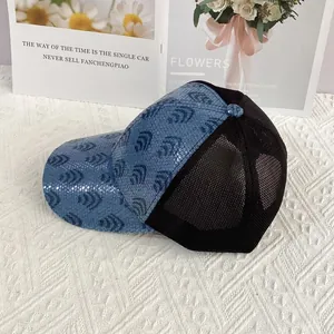 Close-up detail of sequined blue sun hat with mesh back and vintage floral decor