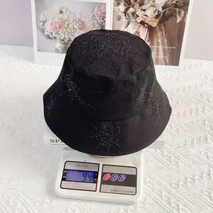 Detail showing heavy rhinestone spider web bucket hat weighing approximately 94 grams