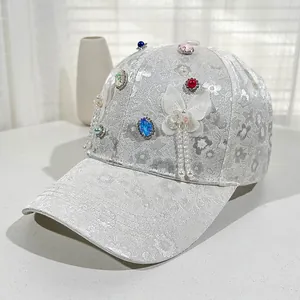 Detail of jacquard baseball cap with colorful rhinestones, pearls and butterfly tassel