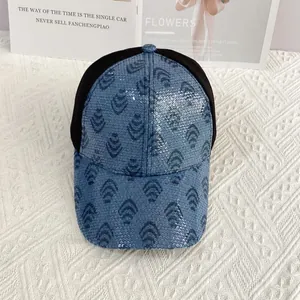 Detail of glitter sequins and blue geometric pattern on mesh back trucker baseball cap