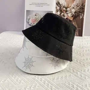 Black and white sun hats with rhinestone spider web pattern in a trendy street style