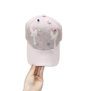 Pink baseball cap with floral texture, colorful rhinestones and butterfly pearl tassels