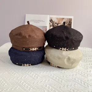 Detail of beret hats with rhinestone butterfly buckle and shimmering starry sequin texture