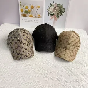 Detail of rhinestone baseball caps in khaki, black, and taupe with ZD letter patterns