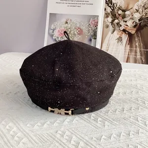 Detail of star-patterned beret featuring a golden butterfly buckle and small rhinestones