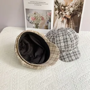 Detail view of retro British plaid newsboy hats with chic polka dot overlays and texture