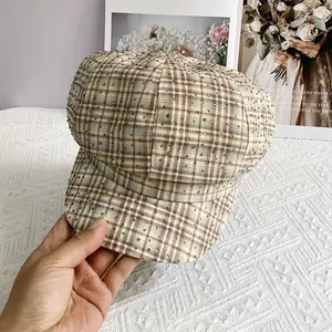 Close-up of British retro plaid newsboy hat with sparkling rhinestone embellishments