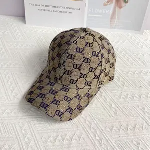 Detailed close-up of khaki baseball cap with blue ZD monogram jacquard and golden sparkles