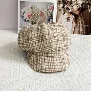 Detail of vintage plaid newsboy hat with sparkling rhinestone studs and retro pattern