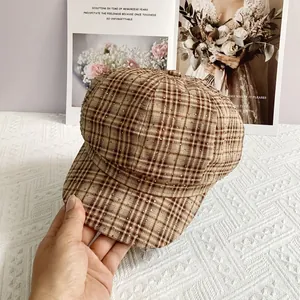 Close-up of British retro brown checkered cap with sparkling rhinestones and curved brim