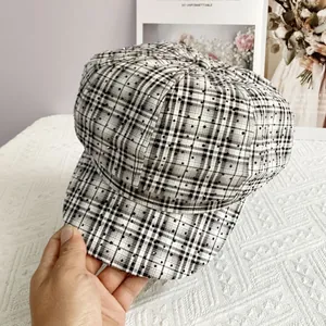 Detailed macro view of black and white checkered newsboy cap with sparkling rhinestones