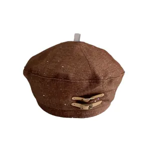 Brown beret hat with leather buckle decoration and stylish snowflake texture