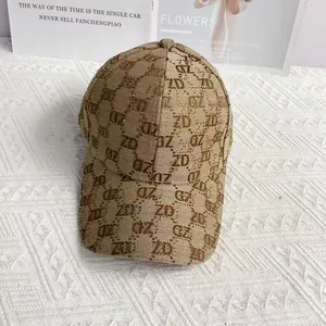 Detailed view of khaki canvas baseball cap with ZD monogram pattern and rhinestone accents