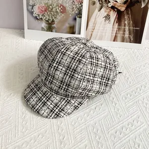 Close-up of vintage black and white plaid newsboy cap with shimmering sequin details