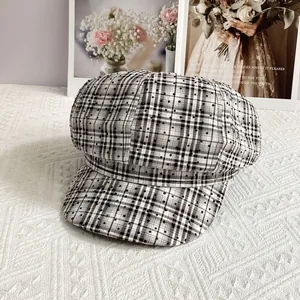 Detail of British plaid baker boy hat featuring sparkling rhinestones and retro check pattern