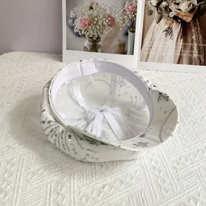 Detailed interior of a white newsboy cap showing star embroidery and sequin craft