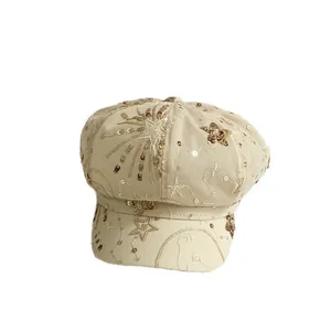 Beige mesh newsboy cap featuring golden sequins and embroidered star and moon patterns
