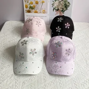 Detail of floral jacquard baseball caps featuring sparkling rhinestone flower embellishments