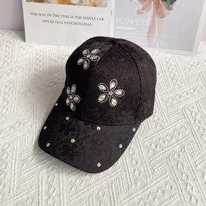 Close-up of black lace baseball cap featuring intricate floral rhinestones and embellishments
