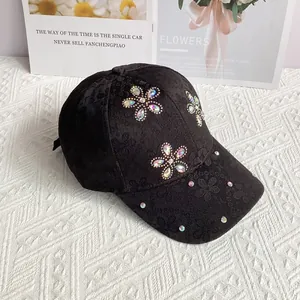 Close-up of black lace baseball cap featuring colorful crystal flowers and sparkling rhinestones