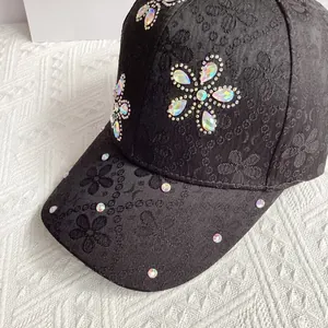 Detailed view of floral embossed satin baseball cap with sparkling crystal rhinestones