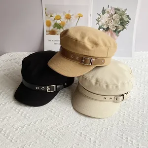 Three cotton linen newsboy hats in black, khaki, and beige with leather buckle detail