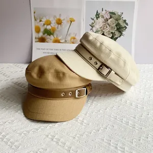 Classic newsboy baker boy hats in beige and khaki with vintage buckle strap details