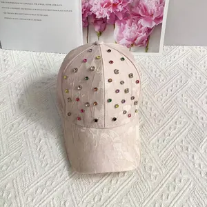 Detail of light pink baseball cap with multi-color rhinestones and textured floral fabric