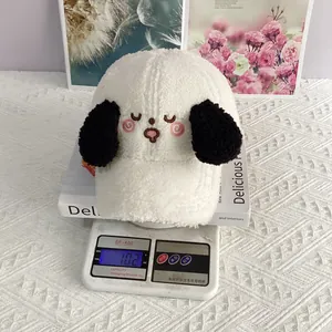 Close-up of white lamb fleece puppy baseball cap featuring 3D ears and cute embroidery