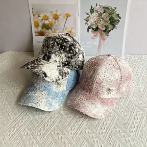 Sequin tweed baseball caps with pearl bow detail in black, blue, and pink colors