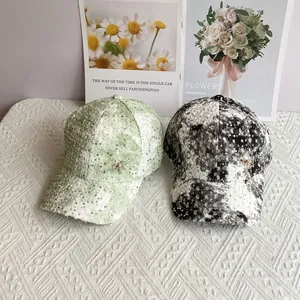 Sparkly sequin baseball cap with tweed texture and metal bow decoration for women