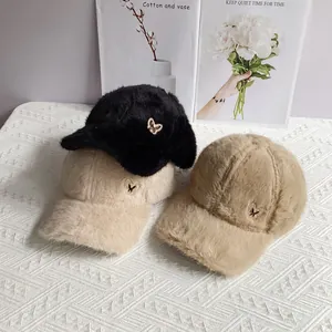 Plush faux rabbit fur baseball caps with rhinestone butterfly pins in neutral colors