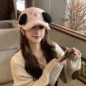 Close-up of pink lamb wool baseball cap with cute embroidered puppy face and black puppy ears