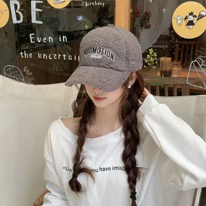 Close-up of plush grey fleece baseball cap with PROMOTION embroidery on female model