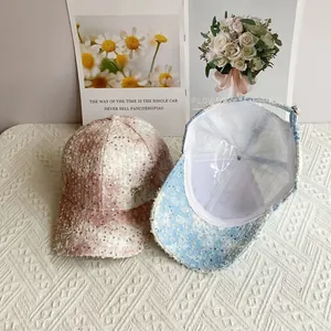 Detail of sequined tweed baseball caps in pink and blue with elegant bow embellishment